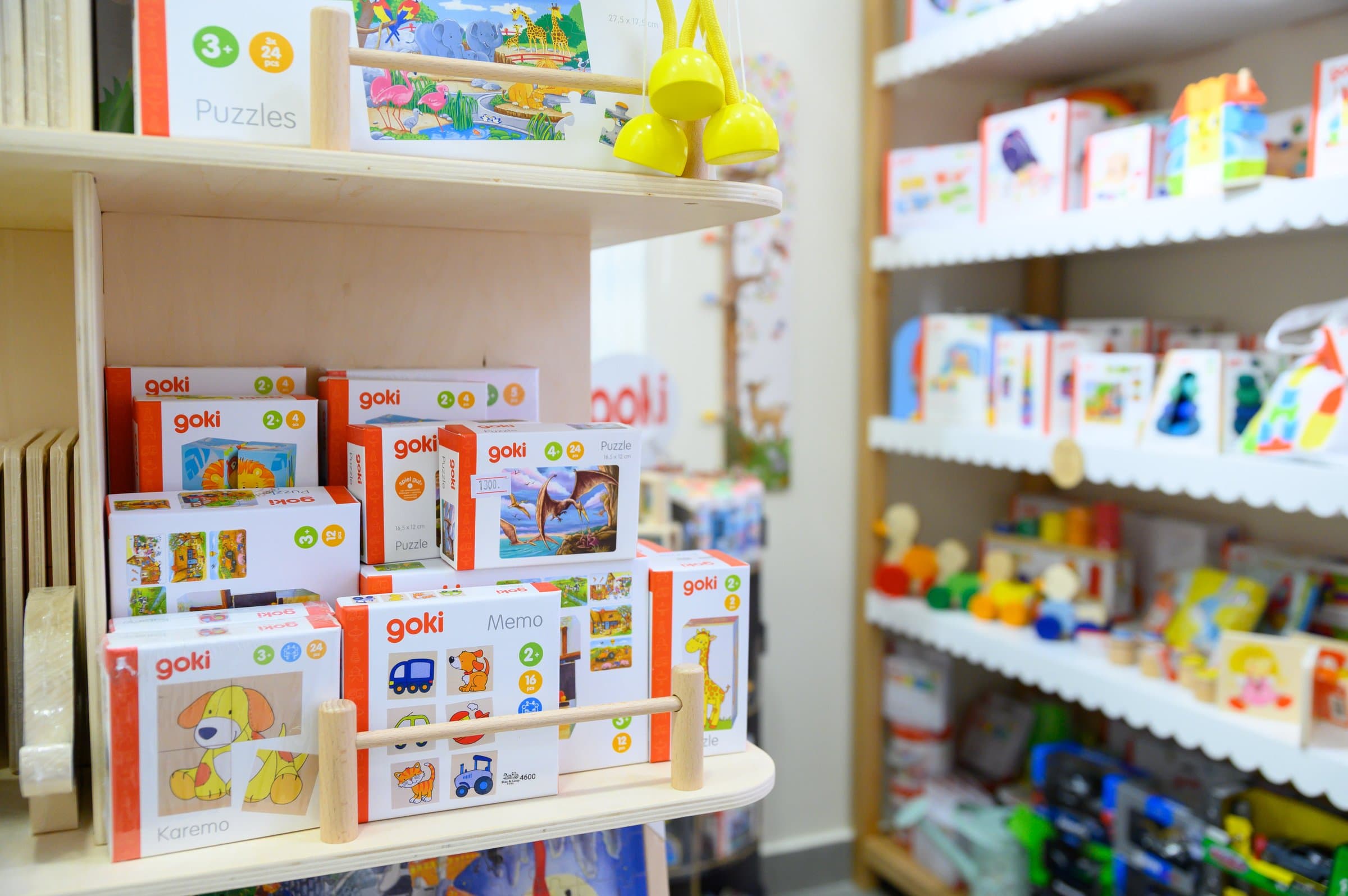 Shelves of wooden jigsaw puzzles and memory games at Max & Lizzy