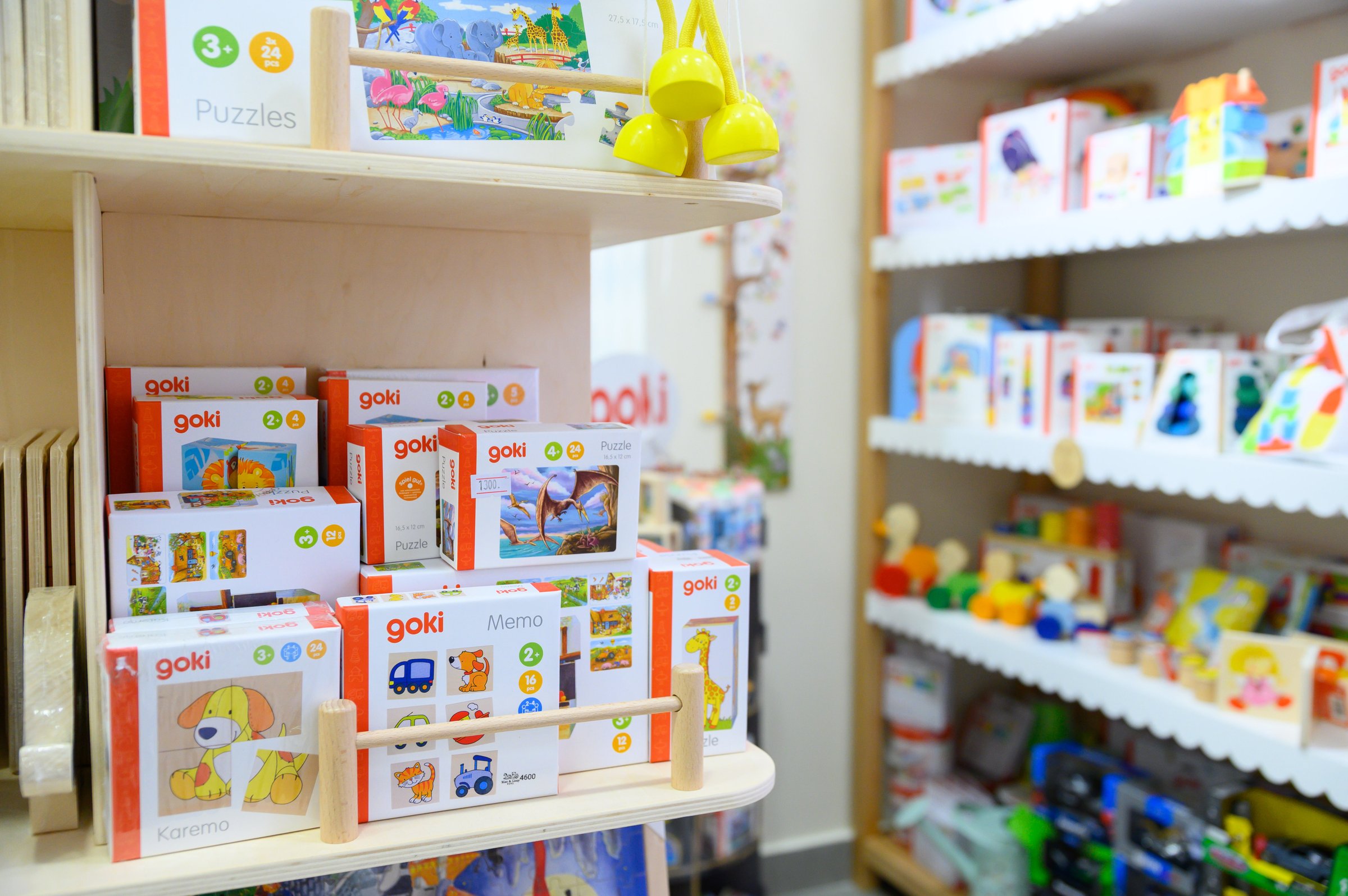 Shelves of wooden jigsaw puzzles and memory games at Max & Lizzy